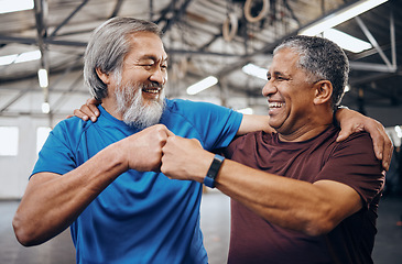 Image showing Men, gym and training with fist bump, smile and teamwork motivation for diversity, friends hug or happiness. Senior fitness partnership, asian and black man for mma workout, exercise or team building