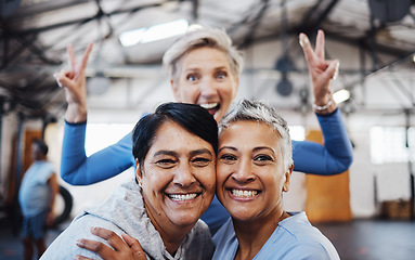 Image showing Business women, senior portrait and happiness of company friends in a warehouse with peace sign. Smile, teamwork hug and mature female group of happy entrepreneur staff ready for working together