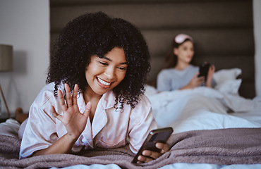 Image showing Video call, phone and wave with black woman at sleepover for communication, internet and contact. Happy, relax and smile with girl and friends in bedroom with technology, digital and social media