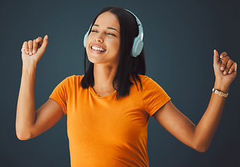 Image showing Dance, black woman or headphones for music, happiness or girl on dark studio background. Dancing, African American female, girl or wireless headset for radio, streaming or listen to audio on backdrop