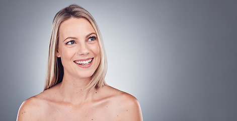 Image showing Woman, thinking and skincare aesthetic with mockup in a studio for wellness and cosmetics. Facial, smile and happy model with gray background and mock up ready for dermatology and self care treatment