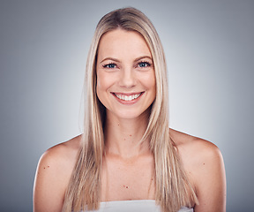 Image showing Woman, portrait and smile with hair and beauty, hairstyle cosmetic care and glow isolated on studio background. Makeup, natural cosmetics and keratin treatment, dermatology and shine with skincare