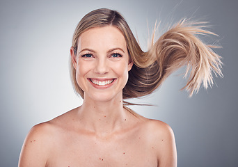 Image showing Woman in portrait, smile and face with hair in air, beauty and keratin treatment, cosmetic care isolated on studio background. Happy model, glow and hairstyle shine, natural cosmetics and skincare