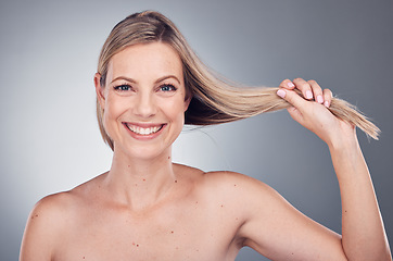 Image showing Hair care, health and portrait of a woman in a studio with a keratin, botox and brazilian hair treatment. Happy, wellness and female model with a long, healthy and shiny hair style by gray background