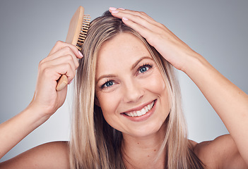 Image showing Portrait, comb or woman with hair care, shine or salon treatment with girl on grey studio background. Face, female or lady brushing scalp, luxury or grooming routine for texture or volume on backdrop