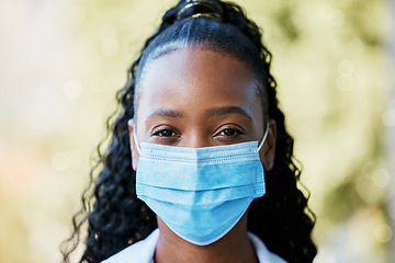 Image showing Covid, portrait and doctor at hospital with mask for compliance, safety and healthcare on bokeh background. Face, corona and female health expert at a clinic for help, goal and innovation outside