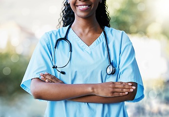 Image showing Healthcare, crossed arms and African female doctor with stethoscope standing in a garden in nature. Happy, smile and professional black woman medical worker in a medicare hospital after consultation.