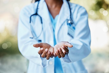 Image showing Healthcare, doctor and hands open to help in giving health care, support and volunteer in hospital in Africa. Black woman medical worker, stethoscope and helping hand in trust working charity clinic.