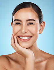 Image showing Wellness, portrait and woman in a studio with a skincare, facial and natural beauty routine. Health, self care and happy female model with a cosmetic face or skin treatment by a blue background.