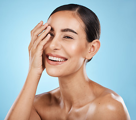 Image showing Beauty, skincare and happy woman in a studio for a wellness, health and natural face routine. Self care, cosmetic and excited female model with a facial skin treatment isolated by blue background.