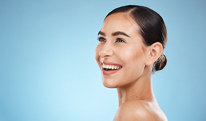 Image showing Happy woman, beauty and isolated on studio background for skincare, cosmetics or makeup with mockup space. Smile on face of model or person with aesthetic, dermatology and facial glow on blue mock up