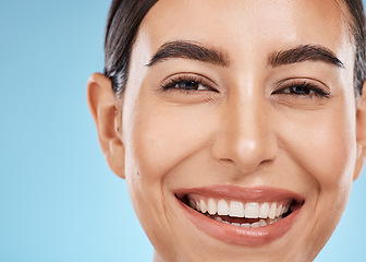 Image showing Portrait, face and skincare with a model woman in studio on a blue background for natural treatment. Beauty, skin and cosmetics with an attractive young female posing to promote a luxury product