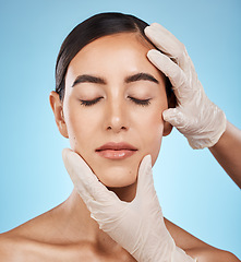 Image showing Cosmetics, plastic surgery and hands check woman face for laser, botox implant or beauty salon. Skincare consultation, facial or gloves for aesthetic change, liposuction and filler on blue background