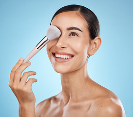 Image showing Face, beauty and makeup brush of woman in studio isolated on a blue background. Thinking, facial treatment and skincare aesthetic of happy female model with tools for foundation, powder or cosmetics