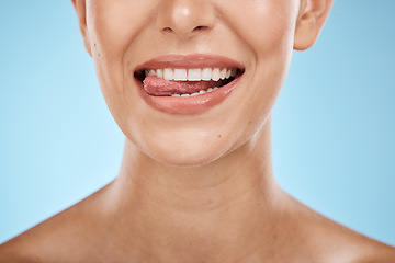 Image showing Dental, health and woman with a smile in a studio for hygiene, wellness and natural oral routine. Healthy, veneers and closeup of female model with clean, beautiful and white teeth by blue background