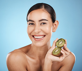 Image showing Kiwi, beauty and portrait of woman isolated on studio background for natural skincare, cosmetics or facial glow. Vegan fruits, product mockup and happy model, person face for dermatology or vitamin c