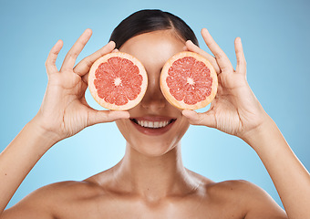 Image showing Skin care, grapefruit and beauty woman fruit face for dermatology, cosmetics and wellness. Aesthetic model for natural sustainable facial glow, nutrition diet and healthy smile on blue background