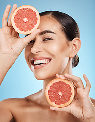 Image showing Portrait, face and skincare of woman with grapefruit in studio isolated on a blue background. Organic cosmetics, food and female model with fruits for nutrition, healthy diet or vitamin c for beauty.