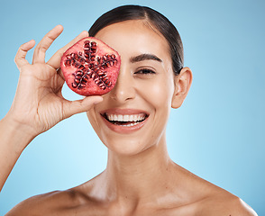 Image showing Beauty, skin care and woman portrait with pomegranate fruit face for dermatology and cosmetics. Aesthetic model person for natural product facial glow, nutrition and healthy smile on blue background