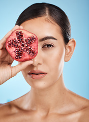 Image showing Skin care, beauty and woman portrait with pomegranate fruit face for dermatology and cosmetics. Aesthetic model person for natural product facial glow, nutrition and healthy diet on blue background