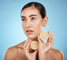 Image showing Lemon skin care, beauty and woman with vitamin c for dermatology, natural cosmetics and wellness. Aesthetic model person for sustainable facial glow, nutrition and detox for face on blue background