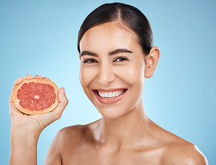 Image showing Beauty, face and grapefruit squeeze woman portrait for dermatology, natural cosmetic and wellness. Aesthetic model person for sustainable facial glow, nutrition diet and skin care blue background