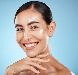 Image showing Skincare portrait, face cream and woman in studio isolated on a blue background. Cosmetics, dermatology and happy female model with lotion, creme or moisturizer for beauty, aesthetics and wellness.