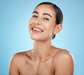 Image showing Portrait, beauty and skin with a model woman in studio on a blue background for natural treatment. Face, skincare and cosmetics with an attractive young female posing to promote a luxury product