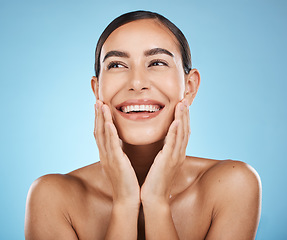 Image showing Face, beauty and skincare of woman in studio isolated on a blue background. Aesthetics, makeup and cosmetics of happy female model with healthy, glowing and flawless skin after spa facial treatment.