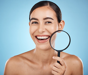 Image showing Face skincare, magnifying glass and beauty of woman in studio isolated on a blue background. Facial portrait, makeup and cosmetics of female model with magnifier lens to check aesthetic wellness.