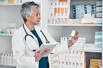 Image showing Medication, tablet and female pharmacist in pharmacy doing research on pills and medicine. Healthcare, medical and senior pharmaceutical worker checking prescription chemist drugs at medicare clinic.