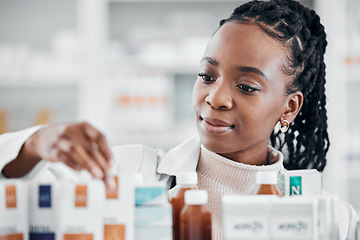 Image showing Pharmacy shelf, medicine and black woman with pills, supplements and medication for wellness in clinic. Healthcare, pharmaceutical store and pharmacist check drugs, vitamins and medical products