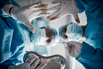 Image showing Doctors, surgery and blood hands in hospital theater with surgeon team for emergency, teamwork and trust. Medical man and woman with glove for life saving, healthcare and health insurance emergency