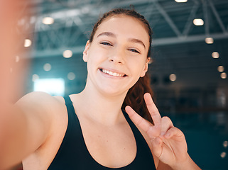 Image showing Peace sign, selfie and portrait of a woman athlete after a swimming exercise, training or competition. Fitness, sports and happy female swimmer taking a picture with a hand gesture after a workout.