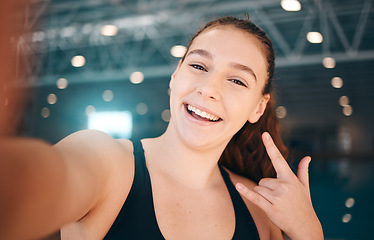 Image showing Selfie, rock and portrait of a girl at a gym for fitness, running and health with a sign for a workout. Happy, sports and face of a girl with a photo, hand emoji and smile for exercise and sport