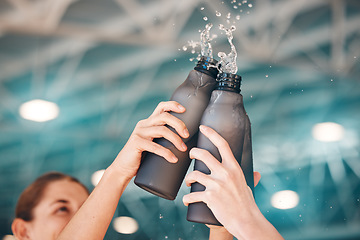 Image showing Cheers, hands and bottle water in sport celebrating victory or achievement after training, fitness or workout. Exercise, group and team winning in unity, support and teamwork with hydration