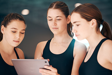 Image showing Girls looking at tablet for fitness data, group of people using iot tech and indoor swimming pool. Instructor showing athletes digital workout, young swimmers use internet and performance analytics