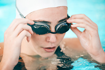 Image showing Swimmer, hands and face with goggles in fitness sports for exercise, workout or training in swimming pool. Sporty athletic woman professional in practice for underwater swim competition in swimwear