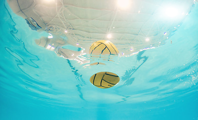 Image showing Water polo, sport and ball in a pool from below with equipment floating on the surface during a competitive game. Fitness, training and exercise while a still life object floats during a match