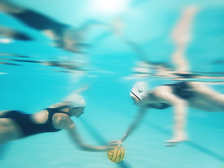 Image showing Water polo, sports and women underwater for a ball during a competition, game or swimming. Teamwork, action and blurred athlete team playing a professional match in a pool for a championship