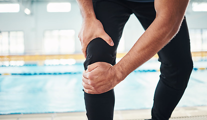 Image showing Hands, knee injury and swimming instructor holding his joint in pain with a pool in the background of a gym. Fitness, coach and anatomy with a sports man suffering from a sore leg during exercise