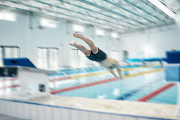 Image showing Swimming, action and man diving in pool for training, exercise and workout for competition at gym. Fitness, sports and motion blur of professional male athlete for dive, jumping and triathlon race