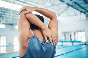 Image showing Rear view, man and stretching at swimming pool for training, cardio and exercise, indoor and flexible. Hand, back and swimmer stretch before workout, swim and fitness routine, warm up and preparation