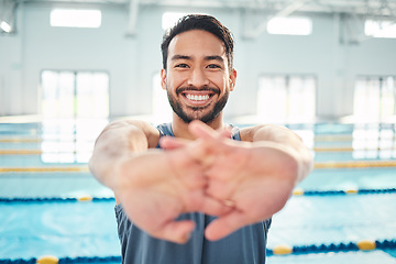 Image showing Portrait, stretching and man at swimming pool for training, cardio and exercise, indoor and flexible. Face, smile and swimmer stretch before workout, swim and fitness routine, warm up and preparation