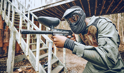 Image showing Paintball, black man and gun with target, sport with fitness and battlefield challenge, war game and soldier outdoor. Safety helmet, extreme sports and exercise, shooting range and military mission