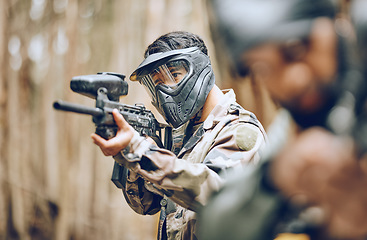 Image showing Paintball, gun and target with man, sports and action outdoor, battlefield and soldier, focus during war game. Extreme sport, aim weapon and military mission, exercise and fitness with team