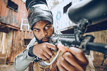 Image showing Paintball gun, shooting and aim in war game for vision, face or tactical strategy for safety in competition. Army training, military warfare games or black man with weapon, combat and focus outdoor