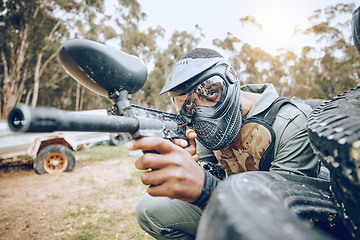 Image showing Paintball, man and gaming, gun and target with sport, fitness on battlefield and challenge with war soldier outdoor. Extreme sports, aim weapon and shooting range with military mission and training