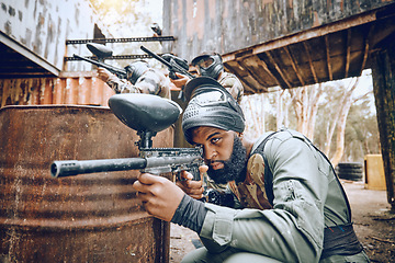 Image showing Paintball, black man and game, gun and target, sport with fitness and battlefield challenge, war and soldier outdoor. Extreme sports, exercise at shooting range and military team with mission