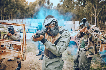 Image showing Teamwork, paintball and sports with people in field for hero, target and shooting games. War, smoke and community with man gamer playing in camouflage for military, army and competition training